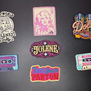 May include: Seven embroidered patches featuring country music themes. Designs include a portrait with text, a playing card, cowboy boots, the name Jolene, two cassette tapes labeled Blonde Bouffant, and the phrase I Beg Your Parton in pink and blue.