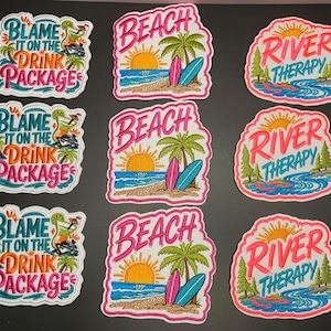 May include: Nine embroidered patches arranged in three columns. The left column features the text Blame It On The Drink Package with a cocktail graphic. The center column shows a beach scene with the word Beach. The right column shows a river scene with the text River Therapy.