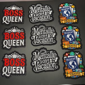 May include: Nine embroidered patches arranged in three columns. The first column features three black patches with red and white text reading BOSS QUEEN and a crown. The second column has three black patches with white text reading Mentally on Vacation. The third column shows three black patches with a blue passport, globe, and travel icons.