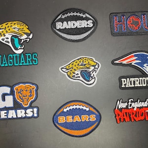 May include: A collection of eight embroidered sports patches featuring various NFL team logos and text, including Jaguars, Raiders, HOU, Patriots, and Bears. The patches are rendered in vibrant colors like teal, orange, blue, red, and silver on a dark surface.