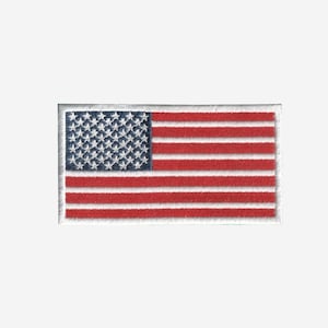 May include: A rectangular embroidered patch featuring the flag of the United States of America. The design includes a blue canton with white stars and alternating horizontal red and white stripes, all finished with a white stitched border.