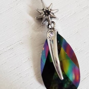 May include: A silver star charm hangs from a beaded necklace with a teardrop-shaped iridescent crystal pendant.