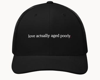 love actually aged poorly. - funny christmas trucker hat