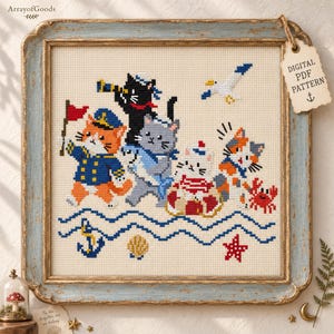 May include: A cross-stitch pattern featuring four cats in nautical attire, including a ginger cat with a flag, a black cat with a telescope, a gray cat, and a calico cat with a life preserver, alongside a crab, seagull, anchor, and starfish.