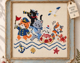 May include: A cross-stitch pattern featuring four cats in nautical attire, including a ginger cat with a flag, a black cat with a telescope, a gray cat, and a calico cat with a life preserver, alongside a crab, seagull, anchor, and starfish.