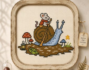 May include: A cross-stitch pattern featuring a grey mouse wearing a red cape riding a large brown snail. The scene includes a blue snail body, red mushrooms, a small lantern, a yellow star, and green foliage on a brown patch of ground.