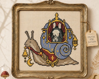May include: A cross-stitch pattern in a gold frame featuring a beige snail carrying a blue carriage with a white rabbit inside. The rabbit has its hands together in a prayer position. A bell and crescent moon hang from the snail's mouth.