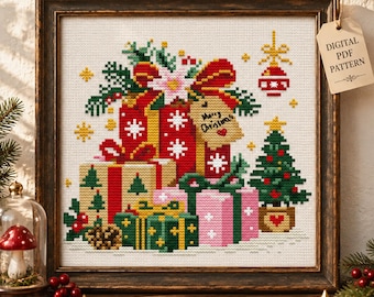 May include: A framed cross-stitch pattern featuring a stack of colorful Christmas gifts, a small decorated pine tree, and a hanging ornament. The gift tag on the presents reads Merry Christmas. The design includes red, green, and pink boxes.