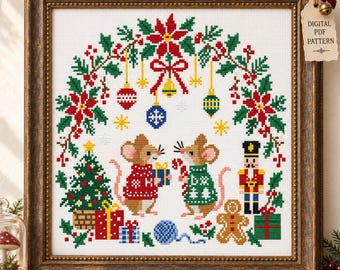 May include: A cross-stitch pattern in a dark wood frame featuring two mice in sweaters, a Christmas tree, a nutcracker, and a gingerbread man under a poinsettia wreath. A tag attached to the frame reads DIGITAL PDF PATTERN.