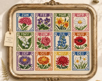 May include: A cross-stitch embroidery piece in a vintage-style gold frame featuring twelve squares, each depicting a month of the year with its corresponding birth flower. The text includes abbreviations for January through December.