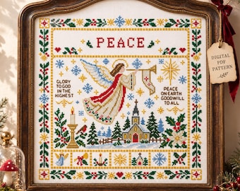 May include: A cross-stitch embroidery in a dark wood frame featuring an angel, a church, and the text PEACE, GLORY TO GOD IN THE HIGHEST, and PEACE ON EARTH GOODWILL TO ALL. The design includes snowflakes, holly, and stars in red, green, and gold.