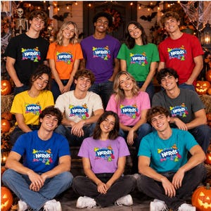 May include: A group of people wearing various colored t-shirts, each featuring the Nerds candy logo and colorful character graphics. The shirts are in black, orange, purple, green, red, yellow, cream, pink, blue, lavender, and teal colors.