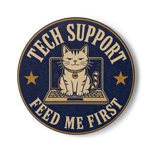 May include: A circular sticker with a dark blue background featuring a tan cat sitting on a laptop. The text TECH SUPPORT is arched above the cat, and FEED ME FIRST is arched below. Two gold stars flank the cat, and it wears a collar with a fish tag.