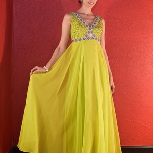May include: A lime green sleeveless maxi dress with a beaded bodice and a V-neckline.