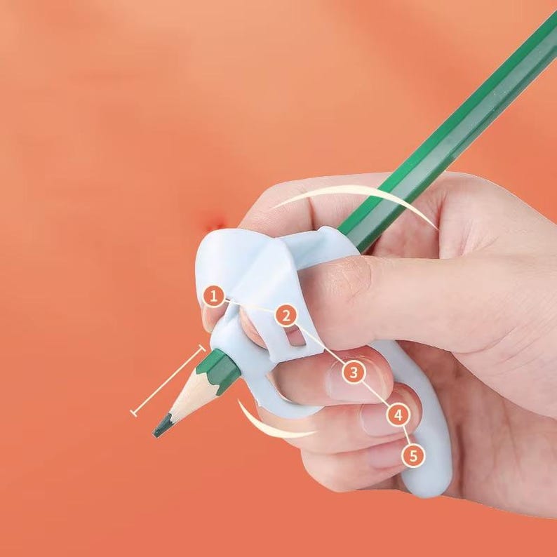 May include: A light blue silicone pencil grip featuring five numbered circular indicators. The grip is attached to a green pencil, designed to assist with finger placement. The device has a contoured shape with specific slots for fingers.