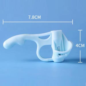 May include: A light blue plastic ergonomic handle attachment for a spray bottle. The device features a trigger-like grip and a circular collar for mounting. It measures 7.8 cm in width and 4 cm in height as indicated by the visible dimension lines.