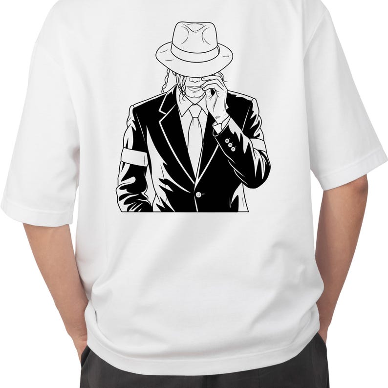 May include: A white short-sleeved t-shirt featuring a black and white graphic illustration of a person wearing a fedora hat, a suit jacket, and a tie, with one hand raised to the brim of the hat. The design is centred on the back of the shirt.