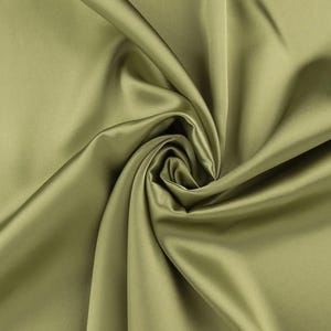 May include: A solid olive green fabric with a smooth, lustrous finish. The material is gathered in the center, creating deep, flowing folds and soft shadows that highlight the reflective quality and uniform texture of the textile surface.