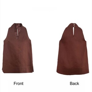 May include: A sleeveless brown top featuring a V-neckline on the front and a high neckline with a keyhole opening secured by two buttons on the back. The garment has a straight hemline with small side slits, shown from both front and back views.