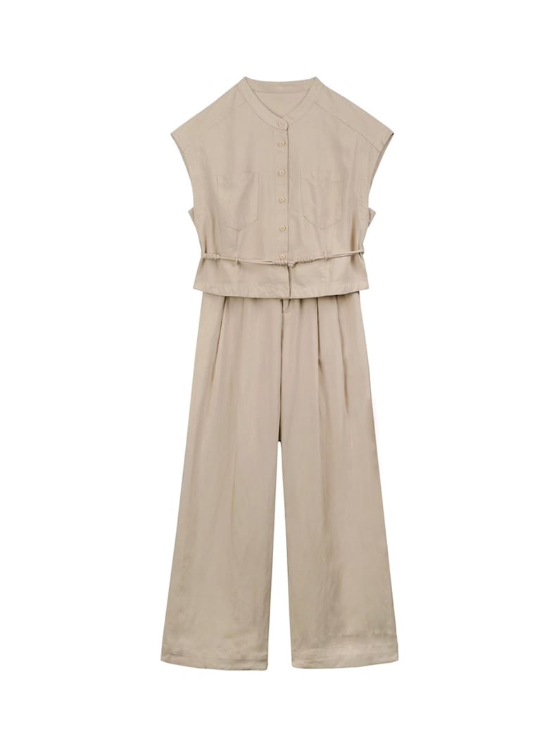 May include: A beige sleeveless jumpsuit featuring a mandarin collar, a button-down front closure, and two chest pockets. The garment includes a thin, integrated waist tie and wide-leg trousers, presenting a clean, monochromatic aesthetic.