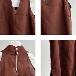 May include: A sleeveless brown top featuring a deep V-neckline, a high collar with two white buttons at the back, a keyhole opening, and side slits at the hem. The garment is constructed with visible seams and a textured fabric finish.