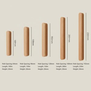May include: Five light-coloured wooden cabinet pulls of varying lengths arranged vertically. Each pull is labelled with dimensions: 100mm, 130mm, 150mm, 200mm, and 230mm. Text below specifies hole spacing, length, and height for each individual wooden handle.