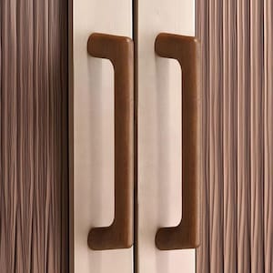 May include: Two vertical door handles made of dark brown wood with a smooth, rounded finish. The handles are mounted on a light-coloured, metallic-looking door panel that features a subtle, vertical, wavy texture across the entire surface area.