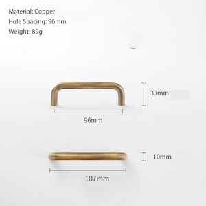 May include: A copper cabinet handle with a brushed finish. The handle has a hole spacing of 96mm, a total length of 107mm, a height of 33mm, and a diameter of 10mm. The weight is 89g. Text on the image includes Material: Copper, Hole Spacing: 96mm, Weight: 89g.