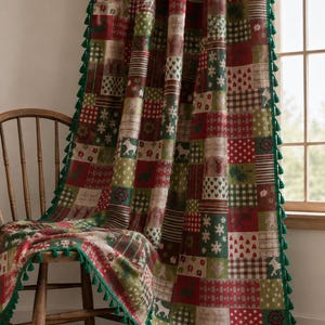 May include: A rectangular throw blanket featuring a patchwork design of red, green, and white squares with patterns of reindeer, snowflakes, hearts, and geometric shapes. The edges are finished with a dark green fringe of small tassels.