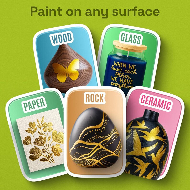 May include: A graphic display with the text Paint on any surface featuring five cards labeled Wood, Glass, Paper, Rock, and Ceramic. The cards show a wooden shape with a butterfly, a blue glass jar with text, gold floral art on paper, a black rock with gold lines, and a black ceramic vase with gold birds.