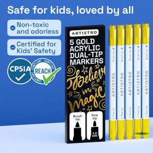 May include: Five gold acrylic dual-tip markers with white barrels and gold caps. The packaging is black with gold text reading 5 GOLD ACRYLIC DUAL-TIP MARKERS and Believe in magic. Features include non-toxic, odorless, and CPSIA and REACH compliance.