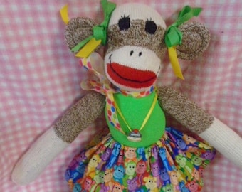 A Rainbow of Monkeys Sock Monkey Doll With Polka-dot Ribbon And monkey Necklace