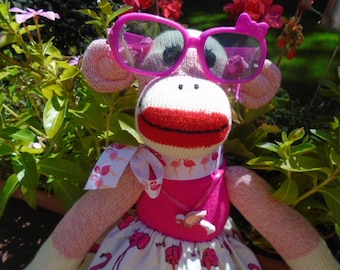 Roze flamingosok aappop met flamingorok, lint en ketting