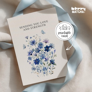 May include: A cream-colored greeting card featuring a watercolor illustration of blue wildflowers and two small butterflies. The text reads, "SENDING YOU LOVE AND STRENGTH." A circular sticker on the card displays a printer icon and the text "printable card."