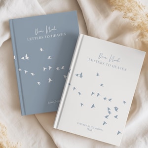 May include: Two hardback journals titled Letters to Heaven. One is dusty blue with white birds and the text Dear Noah, the other is white with blue birds and the text Dear Noah. Both feature personalised inscriptions at the bottom of the covers.