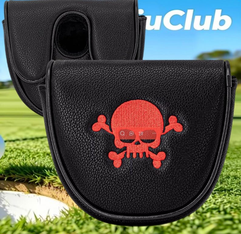 May include: A black textured mallet putter headcover featuring a red embroidered skull and crossbones design on the front. The cover has a rounded shape and a smooth finish. The text "uClub" is partially visible in the upper right corner.