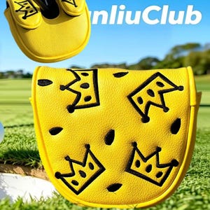 May include: A bright yellow putter headcover featuring a textured surface with embroidered black crown motifs and small black oval accents. The design includes the text "nliuClub" in white lettering. The cover is shaped to fit a mallet-style putter.