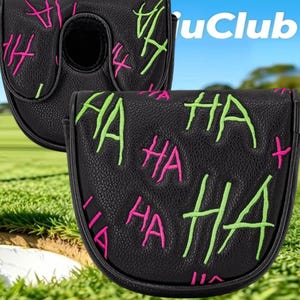 May include: A black putter headcover featuring a textured surface with embroidered "HA" text in bright neon green and hot pink. The design includes multiple repetitions of the word "HA" scattered across the front and top of the protective cover.
