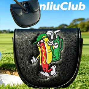 May include: A black leather mallet putter headcover featuring an embroidered cartoon hot dog wearing a green cap and carrying a green golf bag. The design includes white gloves and shoes. The text "nliuClub" appears in white in the upper right corner.