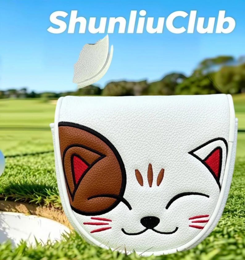 May include: A white mallet putter headcover featuring an embroidered cat face with a brown ear patch, red inner ears, and black whiskers. The text ShunliuClub is printed in white above the headcover. The design includes a small white tab.