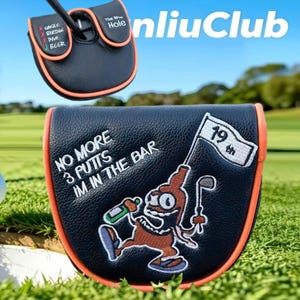 May include: A black leather golf putter headcover with orange trim. The top features a scorecard graphic with text. The front displays an embroidered cartoon character holding a bottle and a golf club, with the text NO MORE 3 PUTTS IM IN THE BAR and a flag labeled 19th.