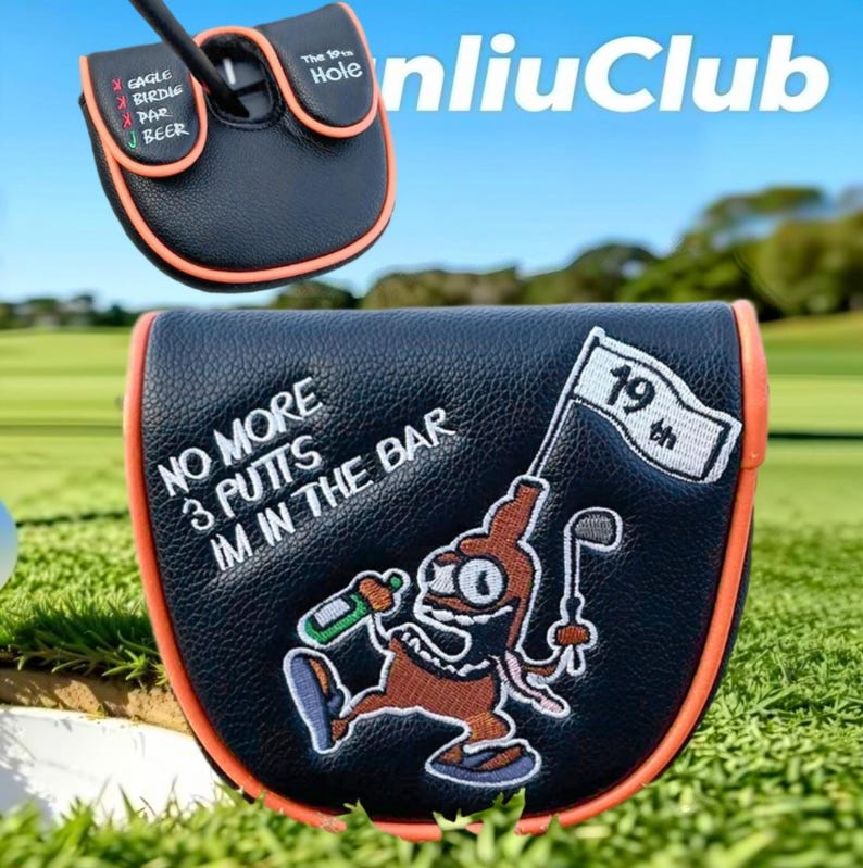 May include: A black leather golf putter headcover with orange trim. The top features a scorecard graphic with text. The front displays an embroidered cartoon character holding a bottle and a golf club, with the text NO MORE 3 PUTTS IM IN THE BAR and a flag labeled 19th.