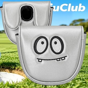 May include: A silver mallet putter headcover featuring an embroidered cartoon face with two large oval eyes and a crooked mouth with visible teeth. The cover has a smooth metallic finish and a black interior lining. The text "iuClub" is visible.