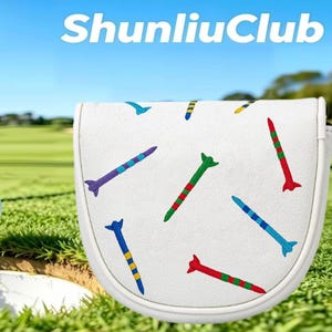 May include: A white golf putter headcover featuring an embroidered pattern of colorful golf tees in red, green, blue, purple, and yellow. The text ShunliuClub is printed in white at the top of the image against a blurred green golf course background.