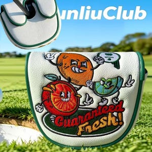 May include: A white golf putter headcover with green trim featuring embroidered cartoon fruit characters including an orange, a lime, and a brown fruit. The text "Guaranteed Fresh!" is embroidered in red and yellow below the fruit characters.