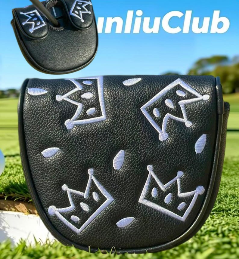 May include: A black putter headcover featuring a repeating pattern of white embroidered crowns and small white petal shapes. The cover has a textured surface and includes a smaller view of the top section with the text unliuClub visible.