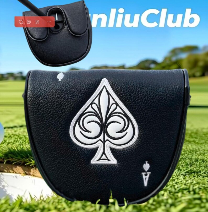 May include: A black leather putter headcover featuring a large white embroidered spade symbol in the center, a small spade icon in the top left corner, and the letter A with a small spade icon in the bottom right corner, with a textured finish.