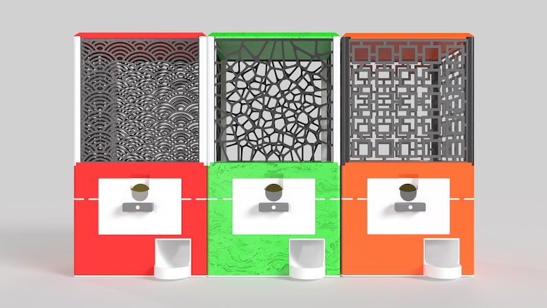 May include: Three colorful, decorative boxes with intricate patterns. The boxes are red, green, and orange, each with a unique design on the top section. Each box has a white dispenser and a small, white cup.