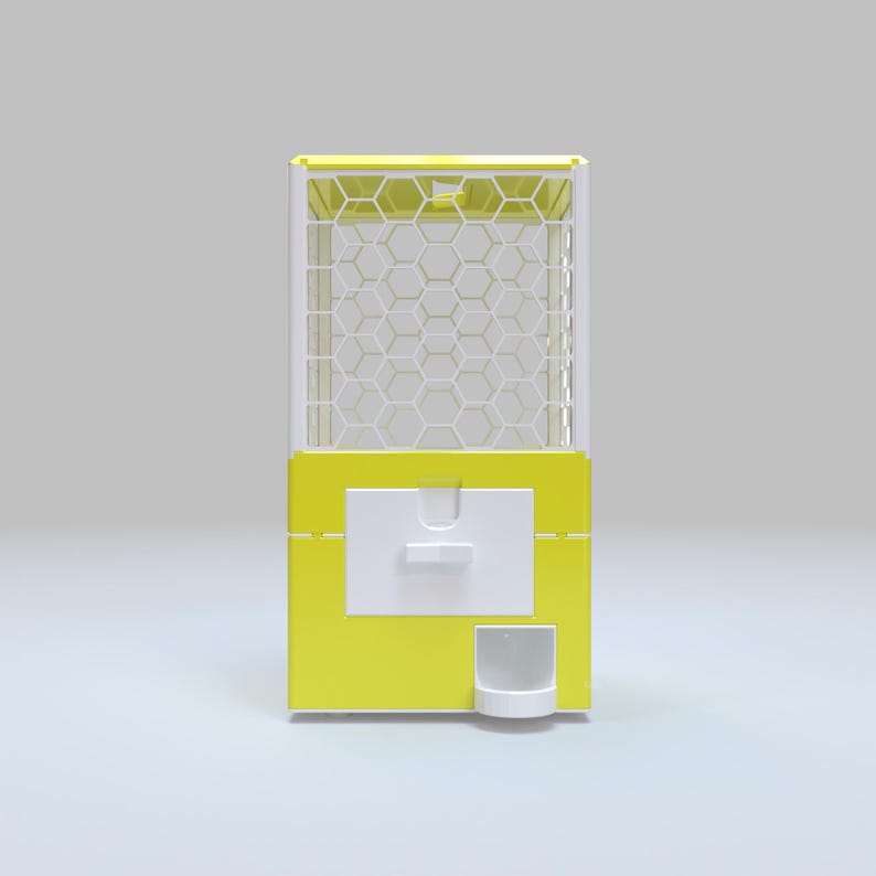May include: A yellow and white gumball machine with a hexagonal pattern on the front. The machine has a white dispensing area and a small white cup at the bottom. The top of the machine is also yellow.