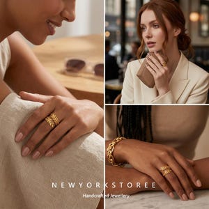 May include: A gold-toned ring featuring a wrap-around leaf design. The band is composed of two overlapping branches with small, textured leaves. The ring is displayed on a finger, showcasing its open-ended structure and polished metallic finish.
